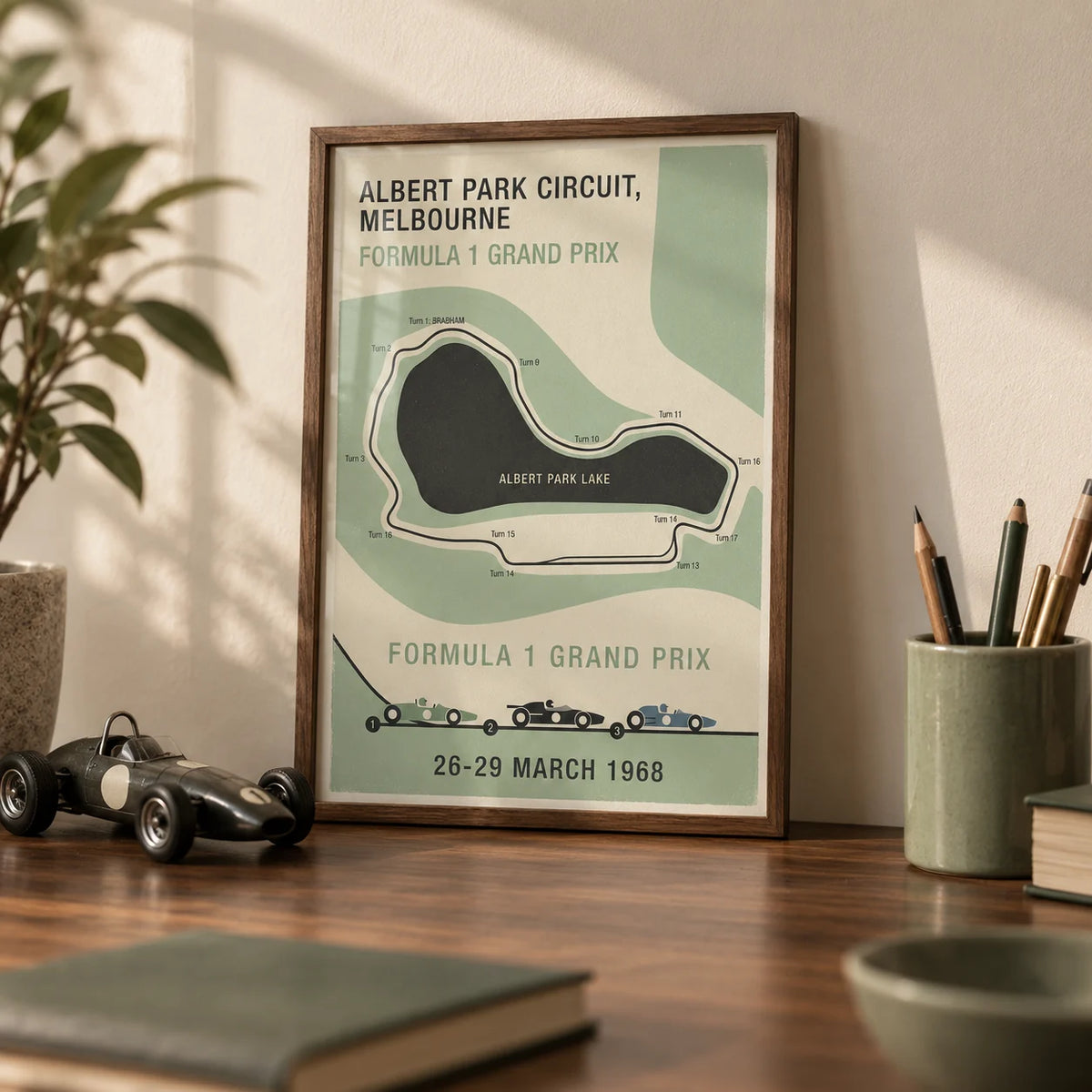Melbourne Park Circuit Poster, a small A4 framed print leaning on a walnut desk