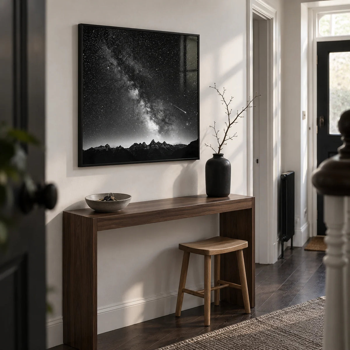 Milky Way Print, framed on the wall of a compact modern hallway in a UK terraced home with a white wall and a dark wood floor