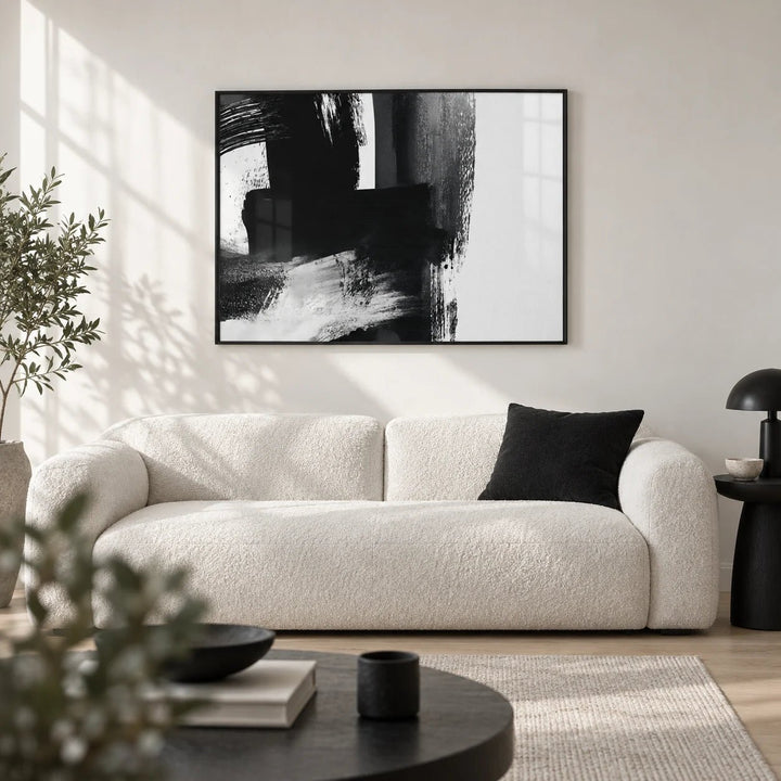 Minimalist Black And White Print, framed on the wall of a crisp monochrome living room with a white wall and a pale oak floor