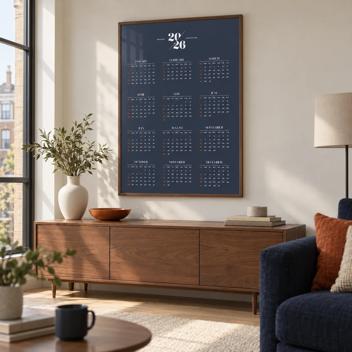 Minimalist Calendar, framed on the wall of a contemporary living room in a UK city flat with warm white walls and a pale oak floor