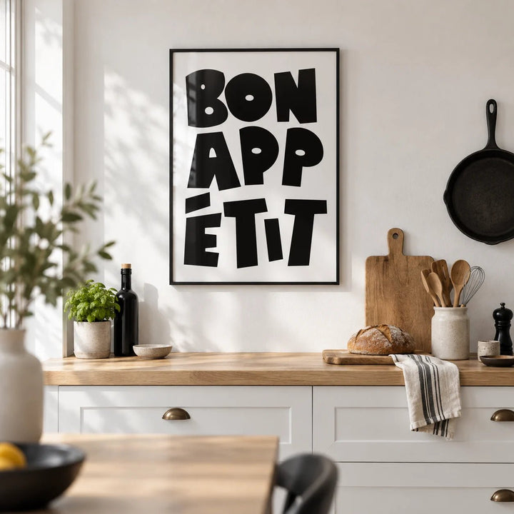 French Art Prints, framed on the wall of a modern white kitchen with a white wall and a pale oak worktop