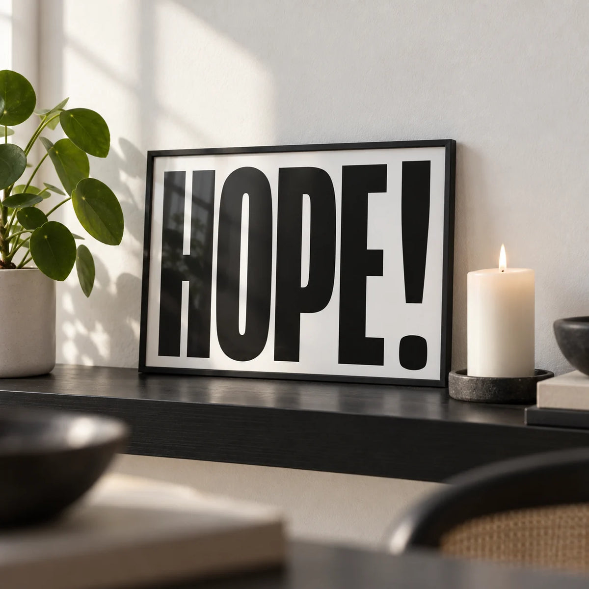 Motivational Work Posters, a small A4 framed print leaning on a black shelf in a living room