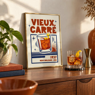 New Orleans Cocktail Print, a small A4 framed print leaning on a walnut sideboard in a living room