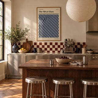 Norwich Print, framed on the wall of a warm kitchen with a burgundy and cream checkerboard tile splashback and brushed steel cabinets