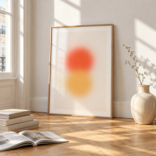 Orange and Yellow Wall Art, framed and leaning on the parquet floor of a bright living room