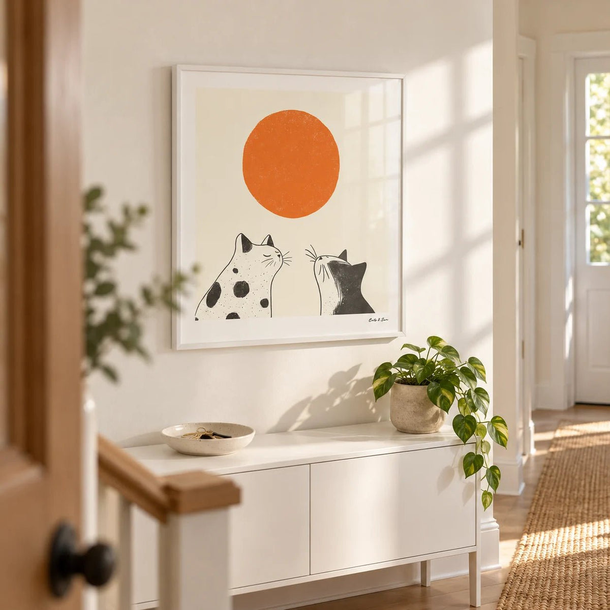 Orange Cat Art, framed on the wall of a bright hallway