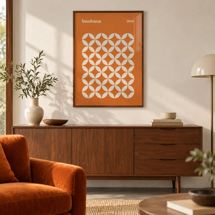 Orange Poster, framed on the wall of a mid-century living room with a warm white wall