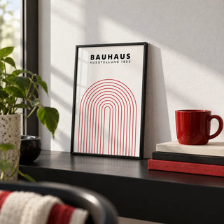 Original Bauhaus Poster, a small A4 framed print leaning on a black shelf in a living room