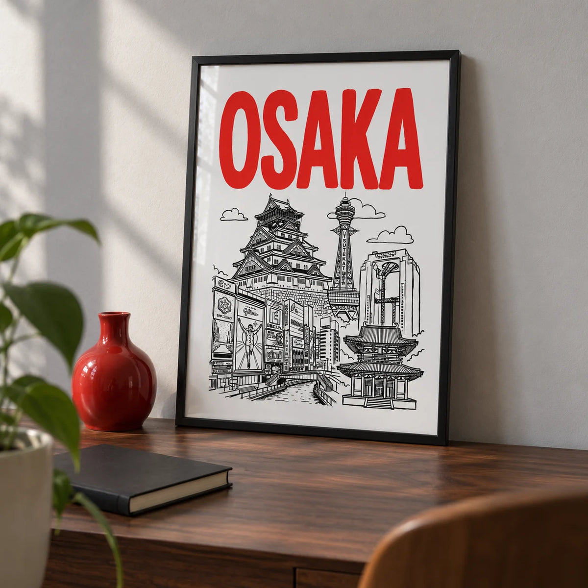 Osaka City Print, a small A4 framed print leaning on a walnut desk