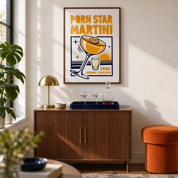Passion Fruit Martini Print, framed on the wall of a compact home bar corner in a design-led UK flat with a white wall and walnut flooring in a living room