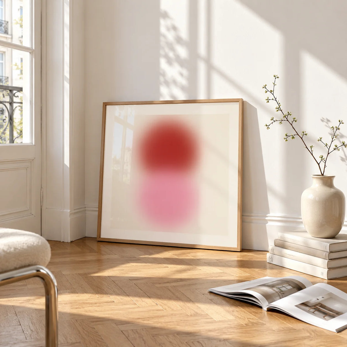 Pink and Red Print, framed and leaning on the parquet floor of a bright living room