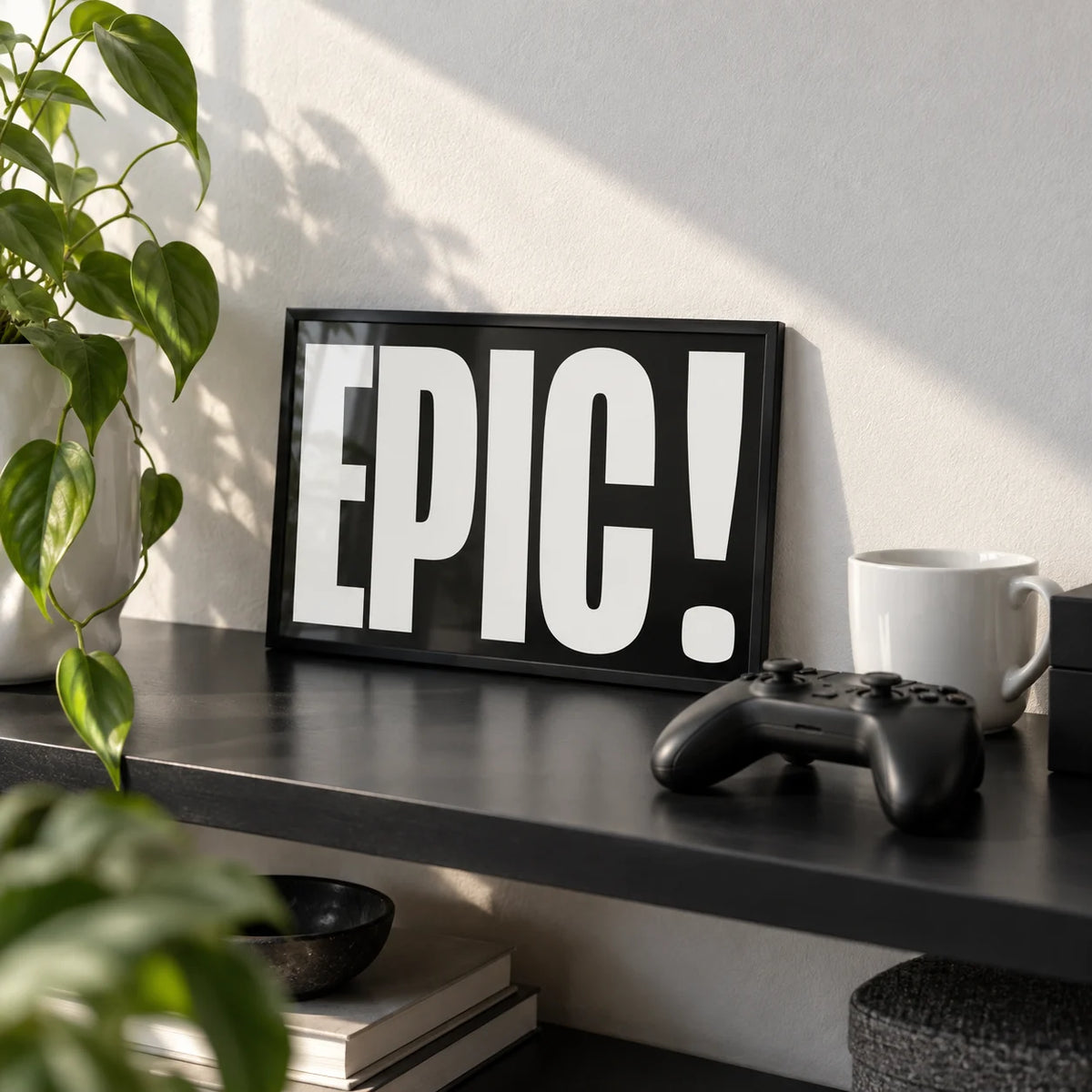 Posters Bold Font, a small A4 framed print leaning on a black shelf in a living room