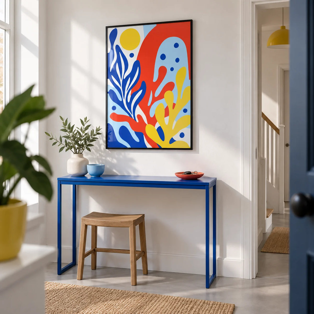 Primary Colours Print, framed on the wall of a crisp hallway in a modern UK maisonette with a white wall and pale grey floor