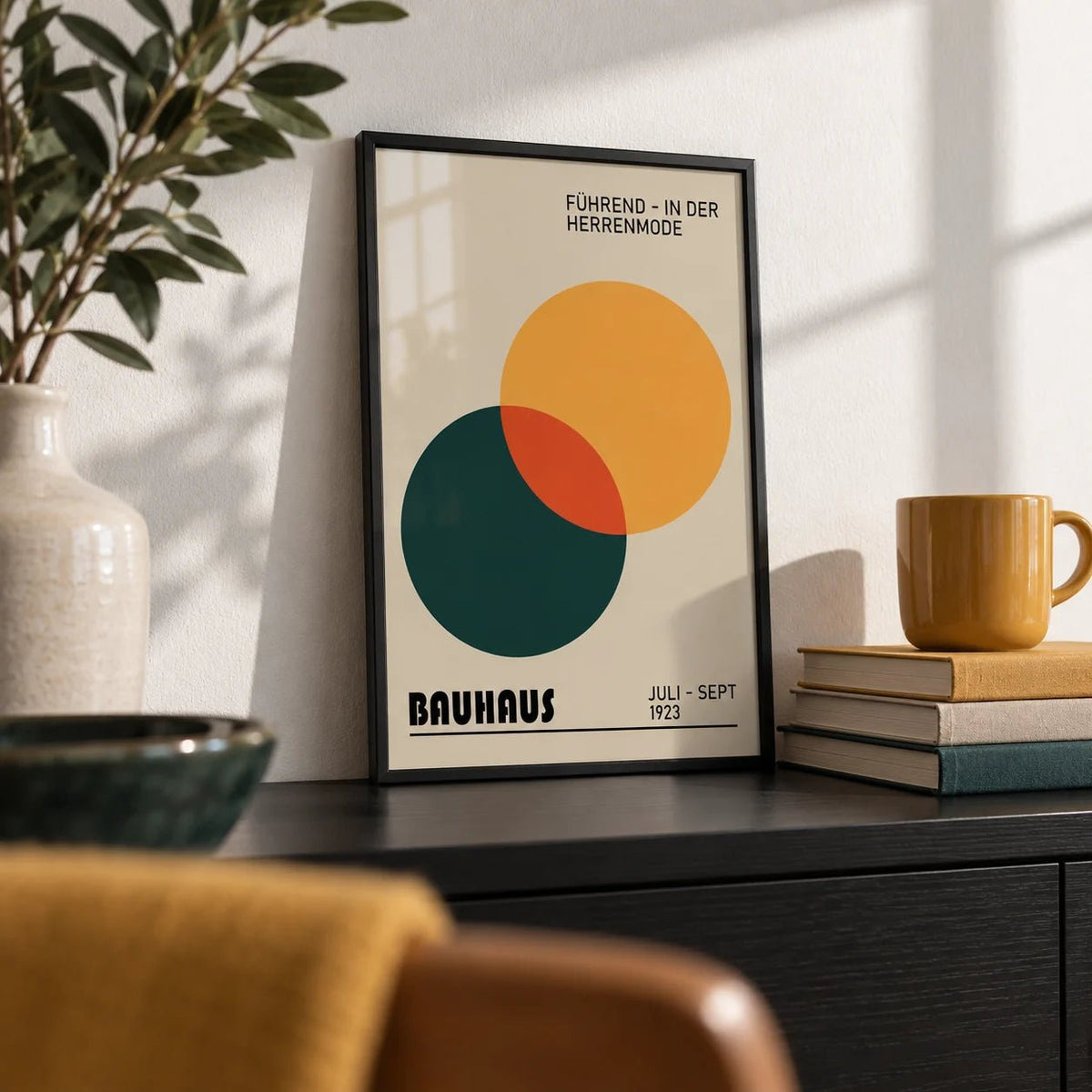 Print Geometric, a small A4 framed print leaning on a black shelf in a living room