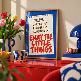 Quote Wall Art, a small A4 framed print leaning on a colourful lacquered shelf in a living room