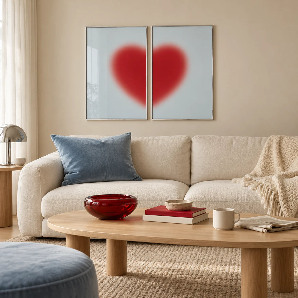 Red heart print set of 2 hung above a cream sofa in a living room