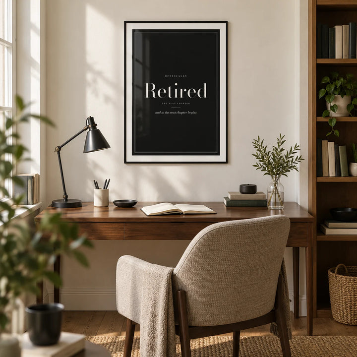 Retirement Poster, framed on the wall of a refined home study in a UK townhouse with a warm white wall and oak floor