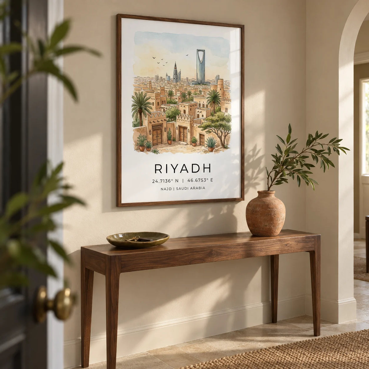 Riyadh Cityscape Wall Art, framed on the wall of a welcoming hallway in a renovated UK townhouse with a pale sand wall and simple limestone floor