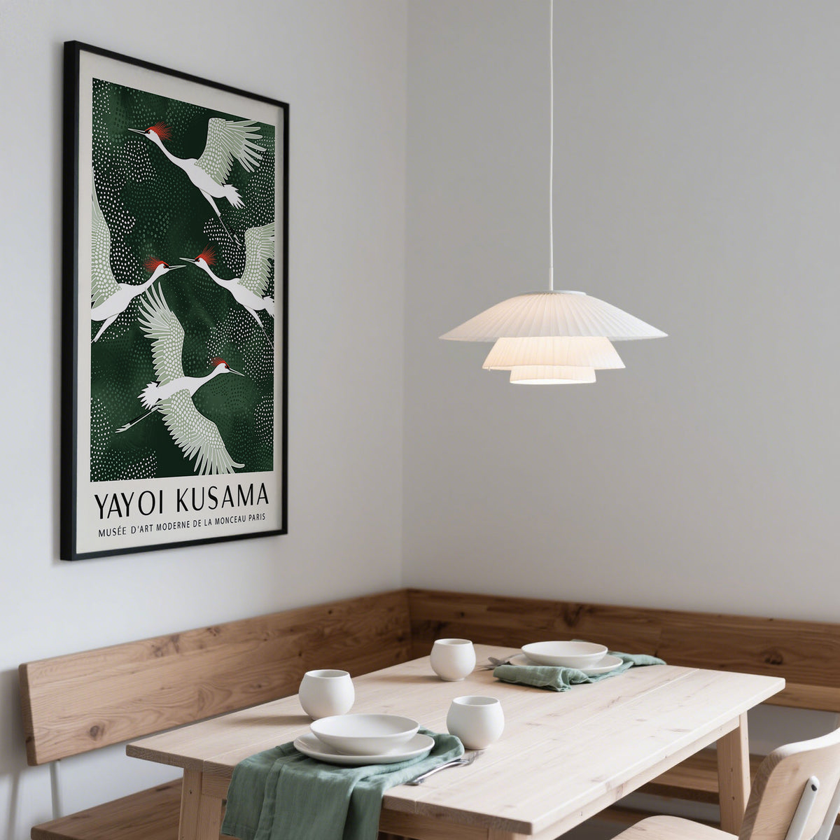 Japandi wall art of red-crowned cranes in flight with green and white tones in a dining room
