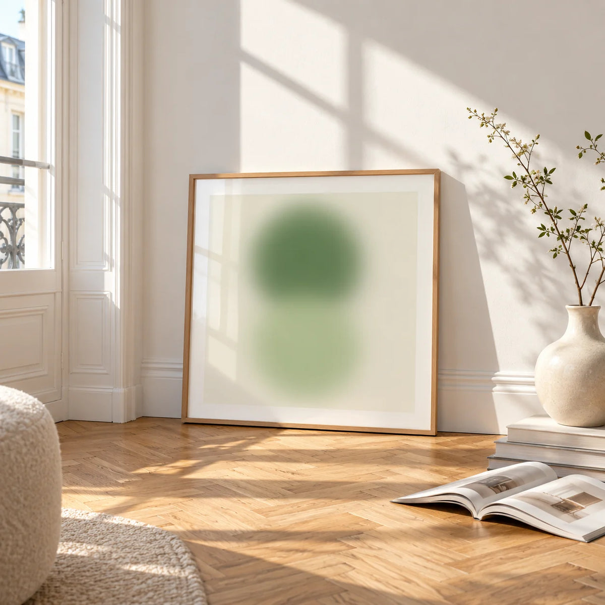 Sage and Olive Print, framed and leaning on the parquet floor of a bright living room