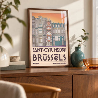 Saint Cyr House Poster, a small A4 framed print leaning on a walnut sideboard in a living room