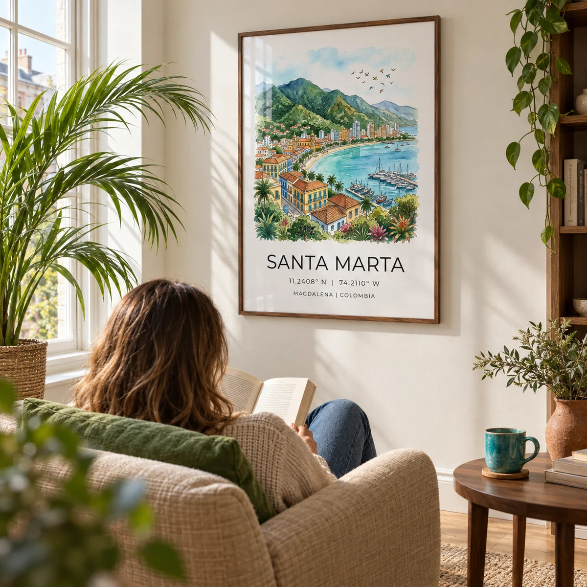 Santa Marta Art Print, framed on the wall of a sunny reading corner in a UK flat with an ivory wall and a tall window in a living room