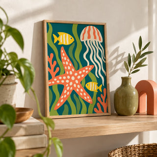 Sea Creatures Print, a small A4 framed print leaning on a pale oak shelf in a living room