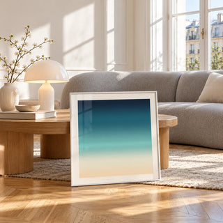 Sea Print, framed and leaning against a coffee table in a bright living room