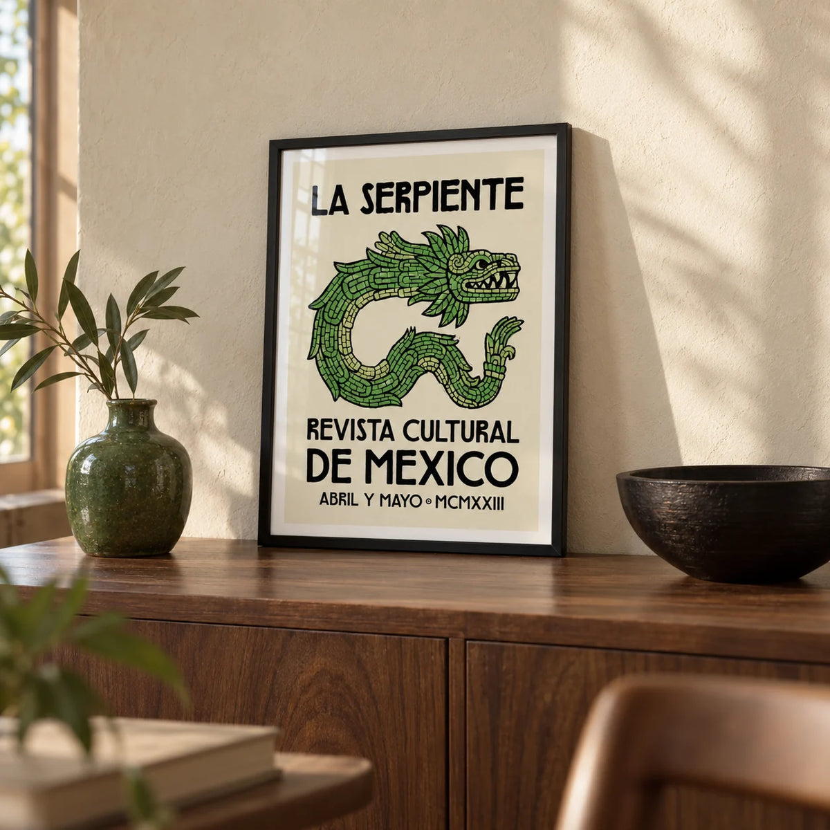 Serpent Cultural Art Print, a small A4 framed print leaning on a walnut sideboard in a living room