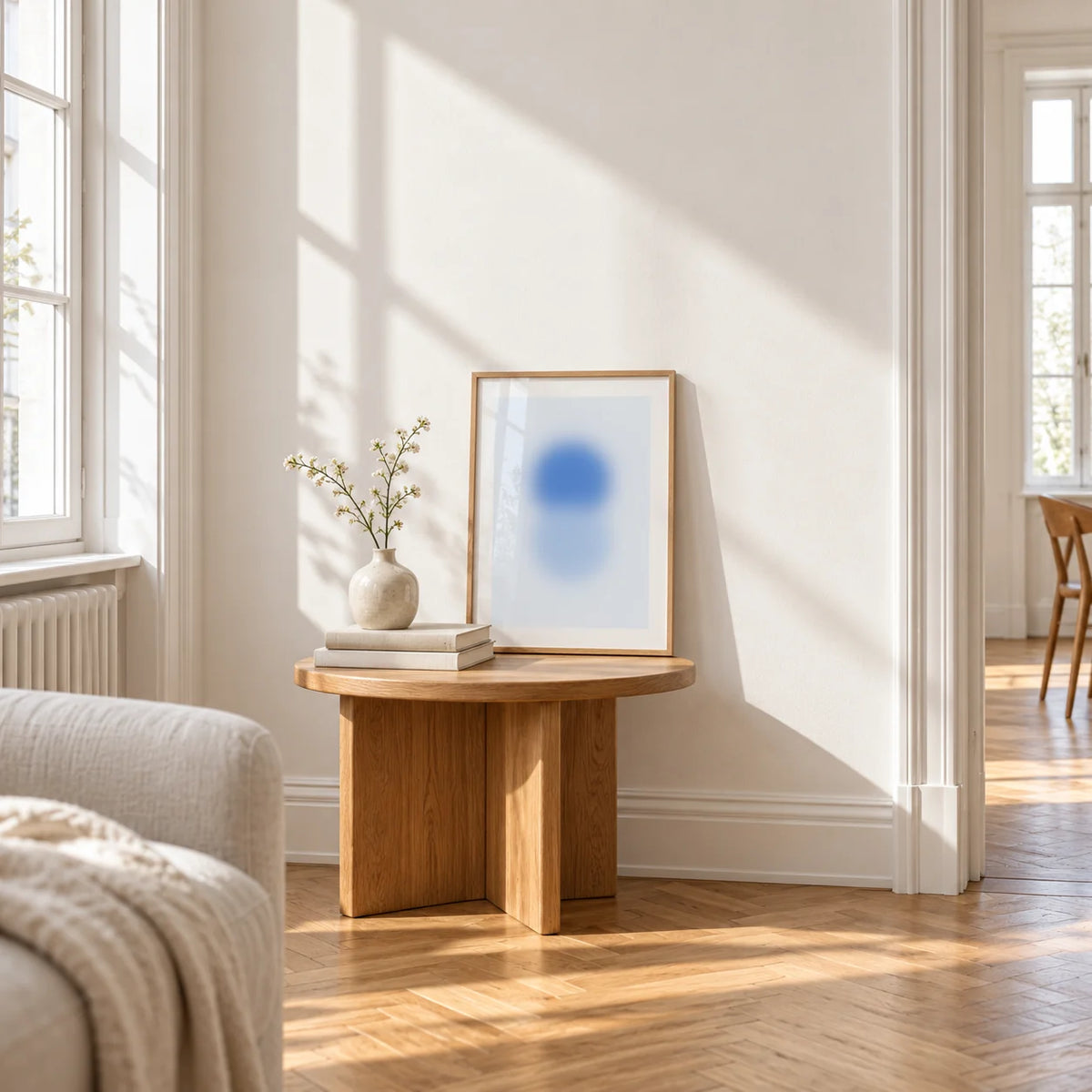 Sky Blue Print, a small A4 framed print leaning on a small solid oak side table