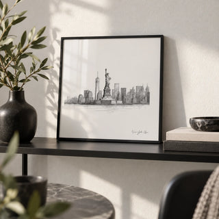 Statue of Liberty Print, a small A4 framed print leaning on a black metal shelf in a living room