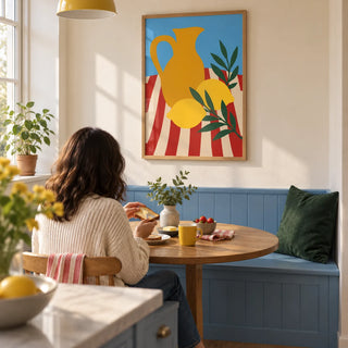 Still Life Poster, framed on the wall of a compact breakfast nook in a first UK flat with a warm white wall and a built-in sky blue bench in a kitchen