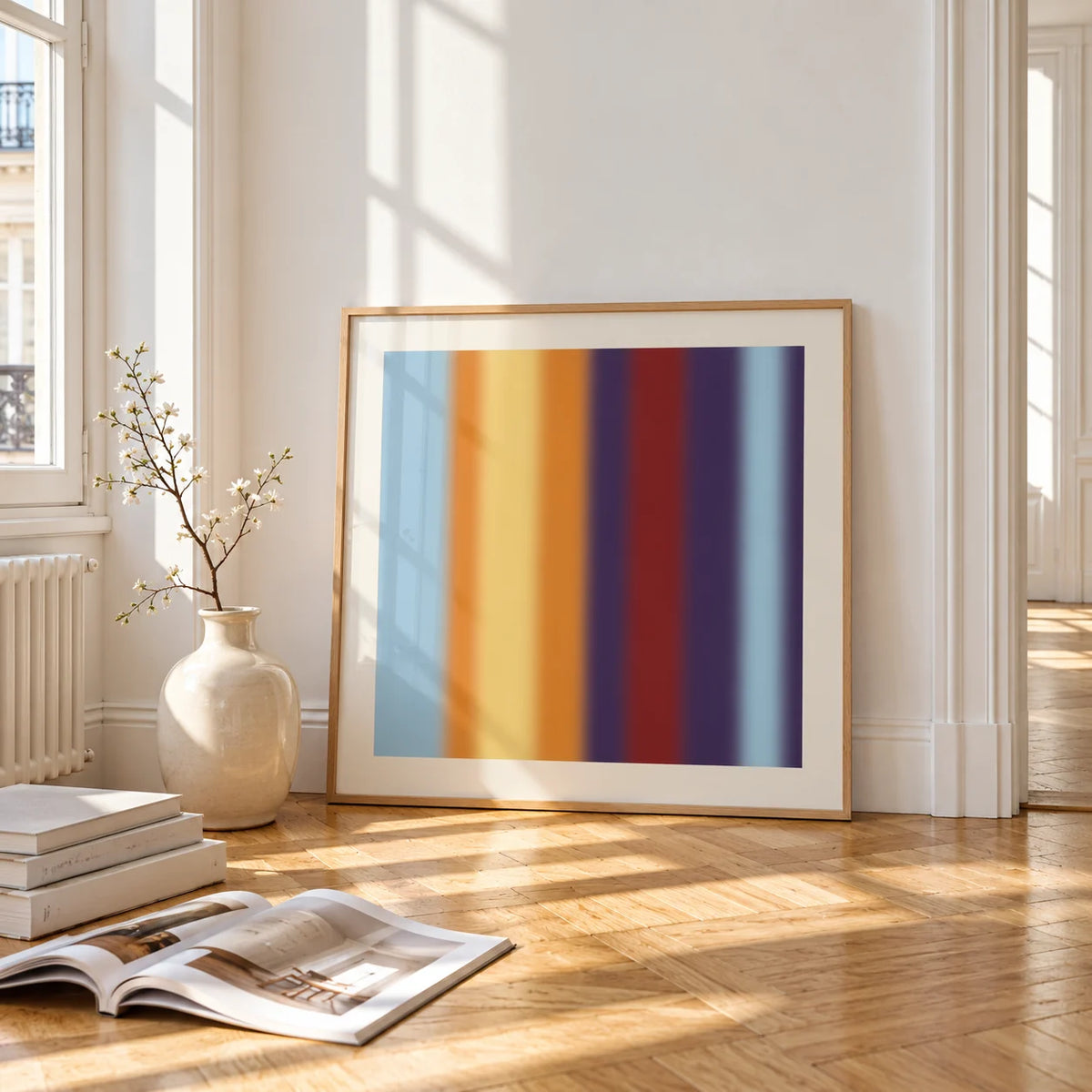 Striped Print, framed and leaning on the parquet floor of a bright living room