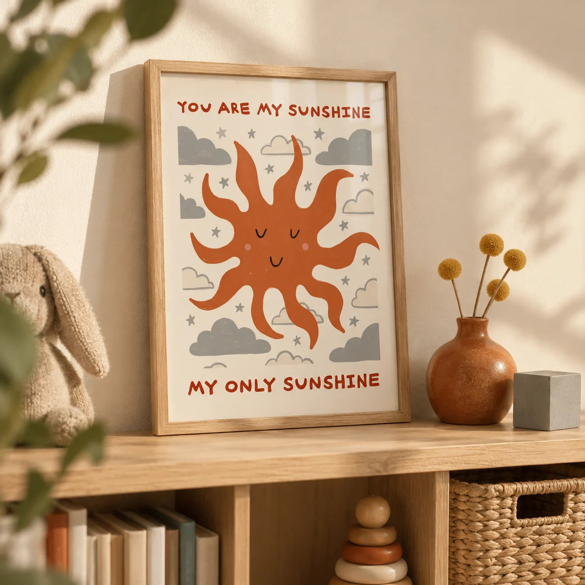 Sunshine Quote Wall Art, a small A4 framed print leaning on a pale oak nursery bookshelf