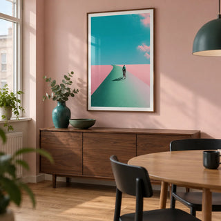 Surreal Cycling Art Print, framed on the wall of a compact modern dining room in a UK flat with a pale pink painted wall and an oak floor