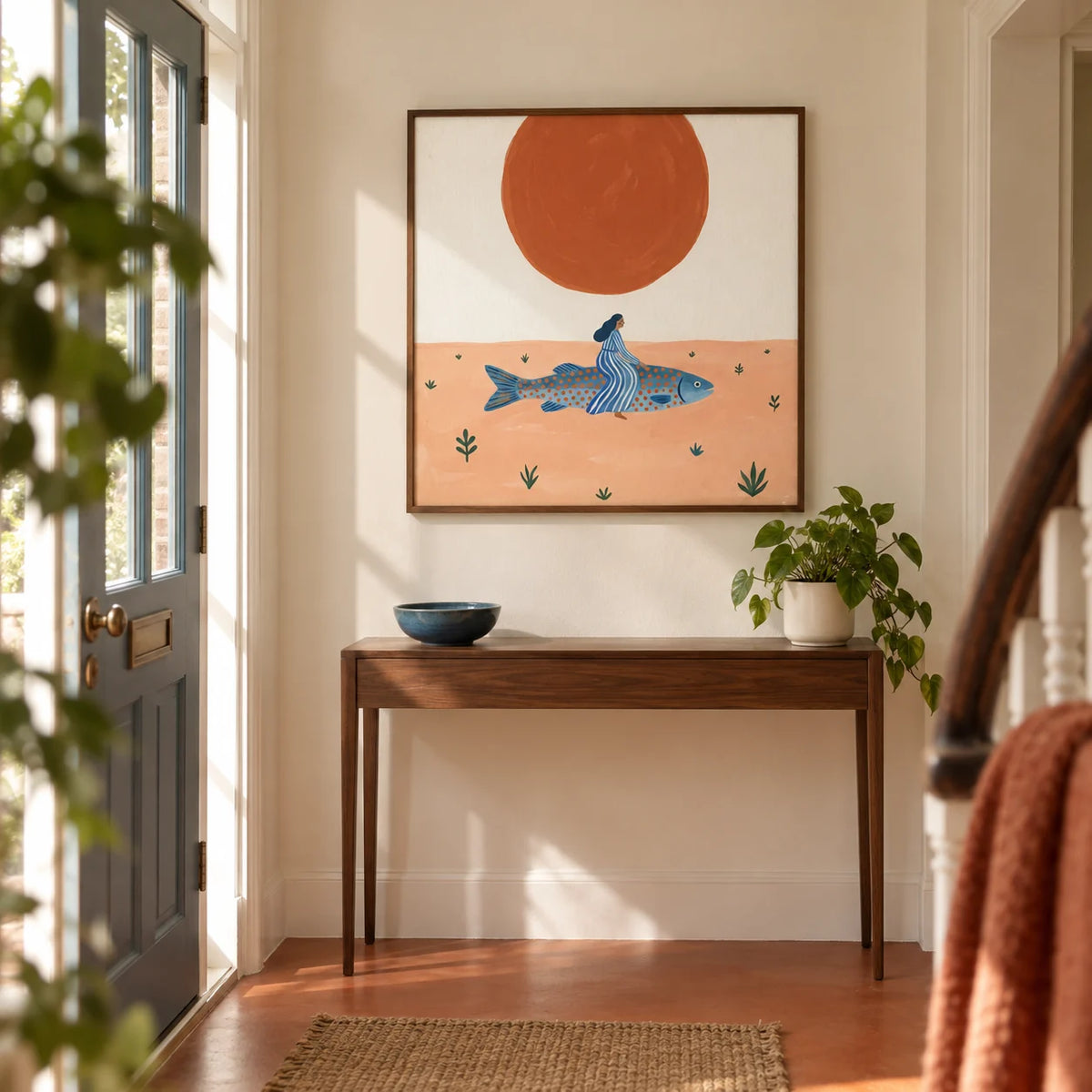 Surreal Fish Art Print, framed on the wall of a welcoming hallway in a renovated UK terrace with warm off-white walls and a plain terracotta floor