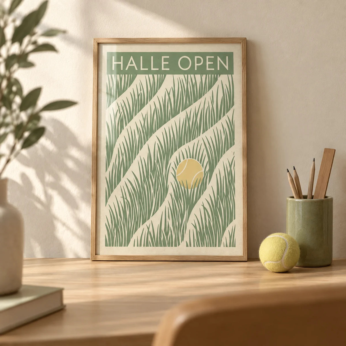 Tennis Grass Art Print, a small A4 framed print leaning on a pale oak desk