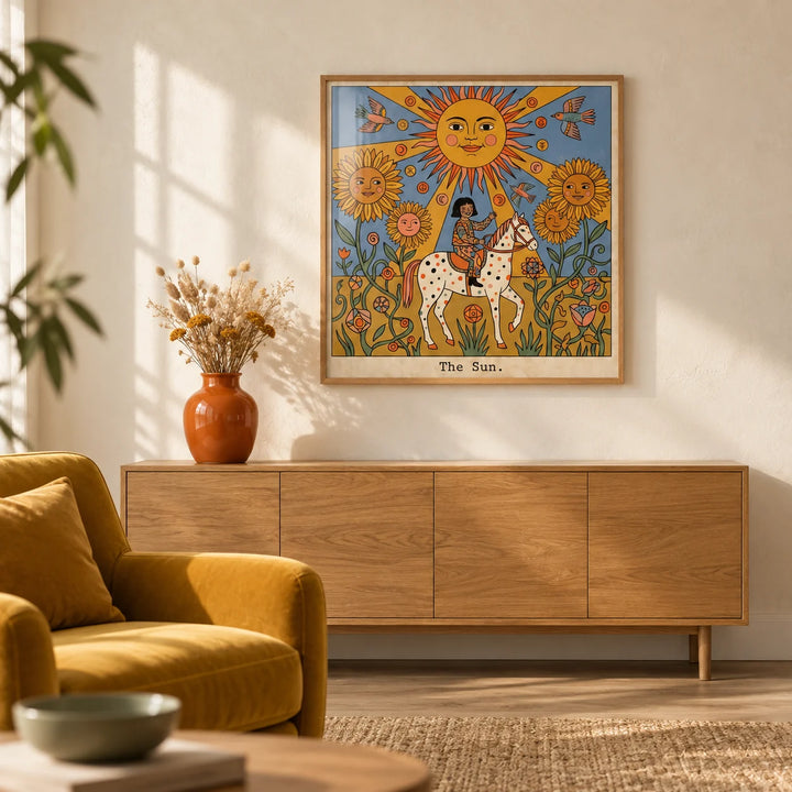 The Sun Tarot Card Art, framed on the wall of a warm boho-modern living room with a plain cream limewashed wall