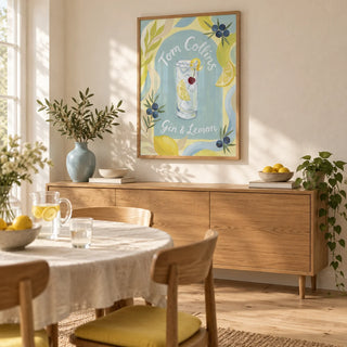 Tom Collins Art Print, framed on the wall of a relaxed dining room in a young couple's UK home with warm white plaster walls and pale oak floorboards