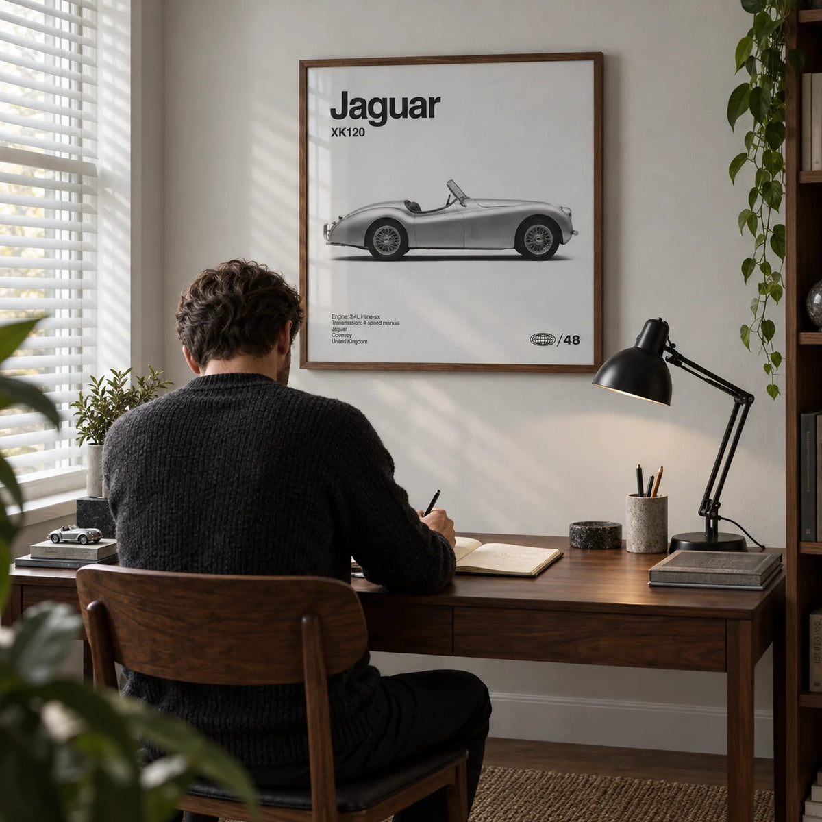 Vintage 1950s Roadster Poster, framed on the wall of a compact home study for a classic-car enthusiast with a pale grey wall and a walnut desk