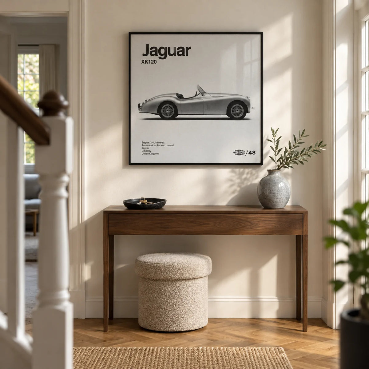 Vintage 1950s Roadster Poster, framed on the wall of a welcoming hallway in a renovated British semi-detached home with warm white walls and an oak parquet floor
