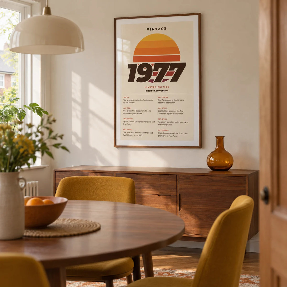 Vintage 1977 Birthday Print, framed on the wall of a mid-century-inspired dining room in a British semi-detached home with cream walls and a round walnut dining table