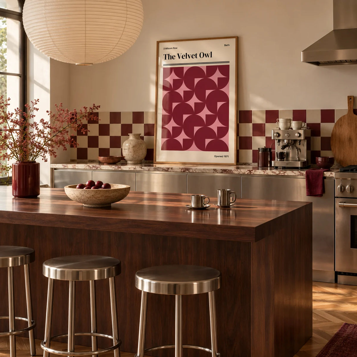 Vintage Bath Poster, framed on the wall of a warm kitchen with a burgundy and cream checkerboard tile splashback and brushed steel cabinets