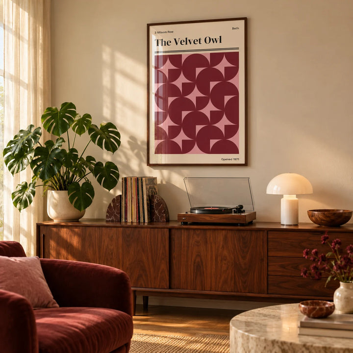 Vintage Bath Poster, framed on the wall of a warm living room with soft golden light through a sheer curtain