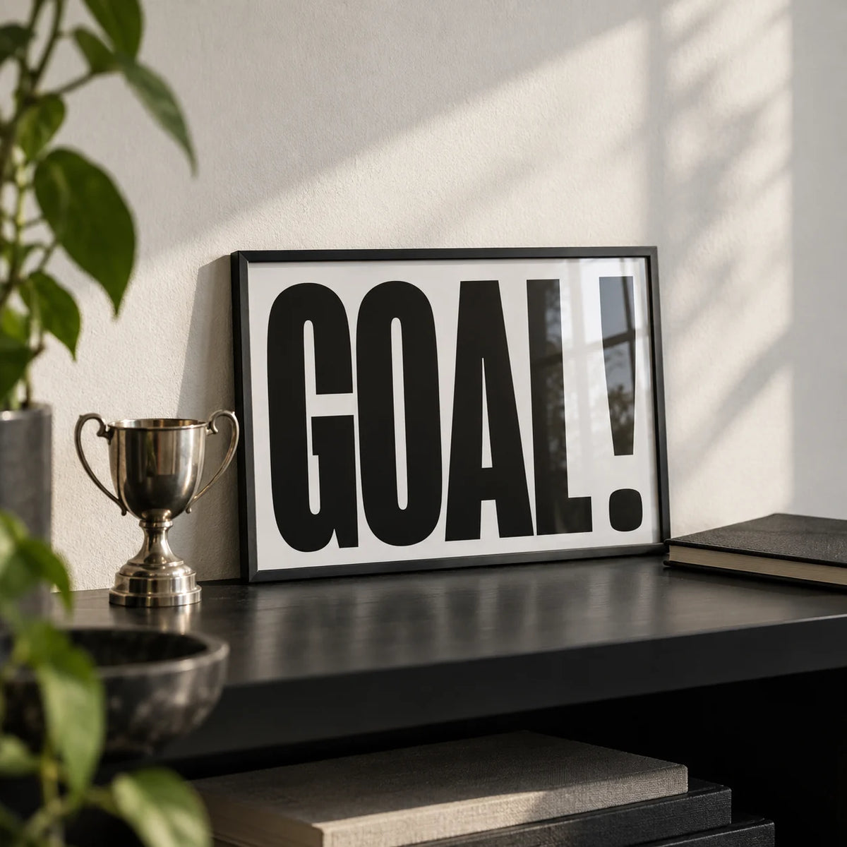 Wall Art for Games Room, a small A4 framed print leaning on a black shelf in a living room
