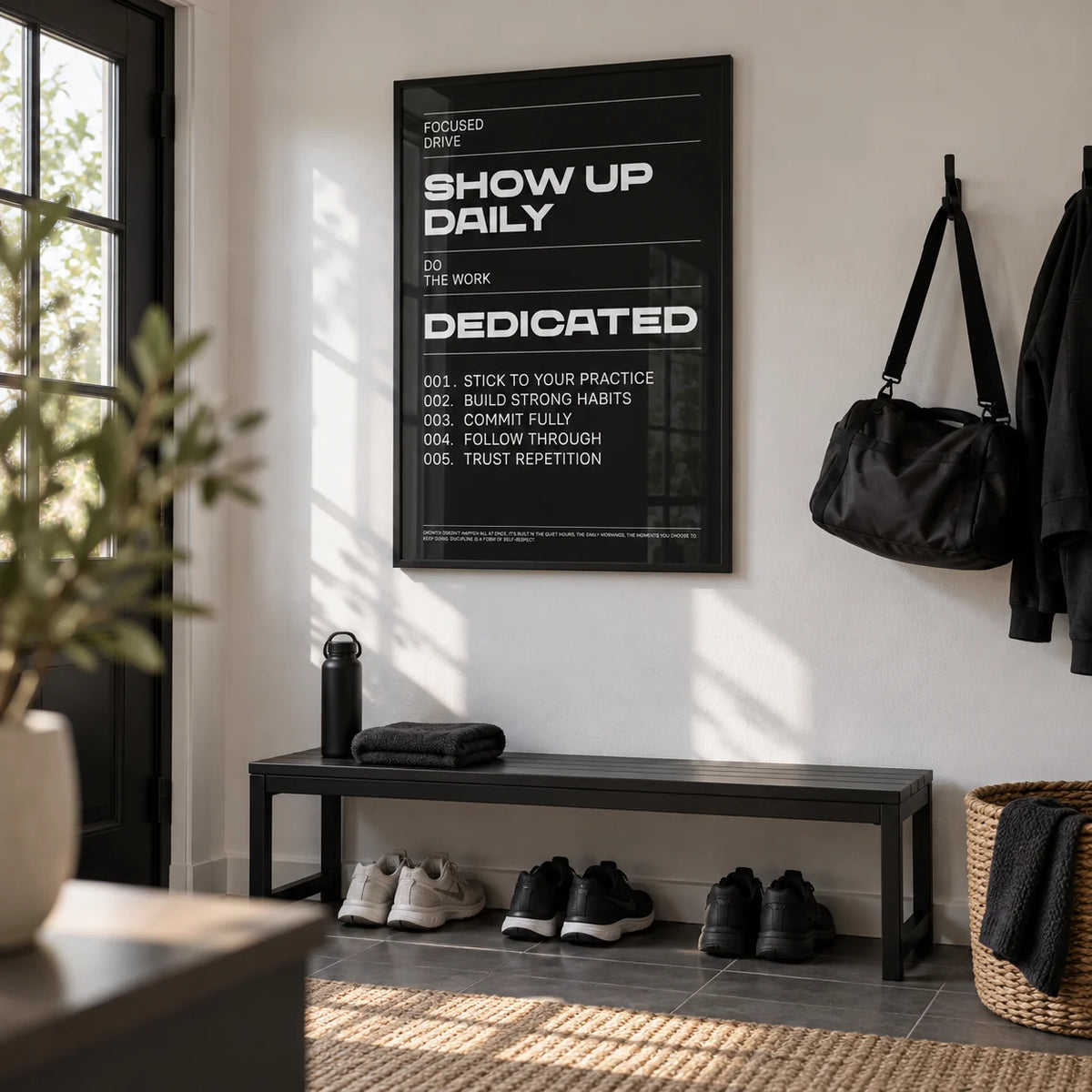 Wall Art Work, framed on the wall of a modern boot room by the back door with a white wall in a hallway