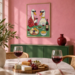 Wine And Cheese Poster, framed on the wall of a playful bistro-style dining room with a bubblegum pink limewashed wall