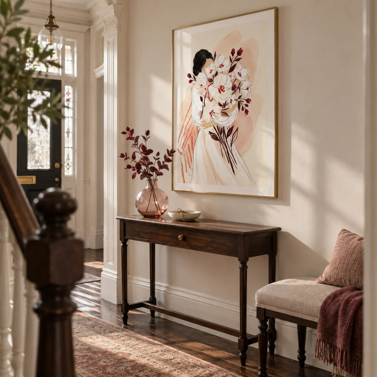 Woman Holding Flowers Print, framed on the wall of a welcoming hallway in a Victorian terrace with soft ivory walls and restored dark wooden floorboards
