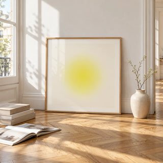 Yellow Wall Art, framed and leaning on the parquet floor of a bright living room