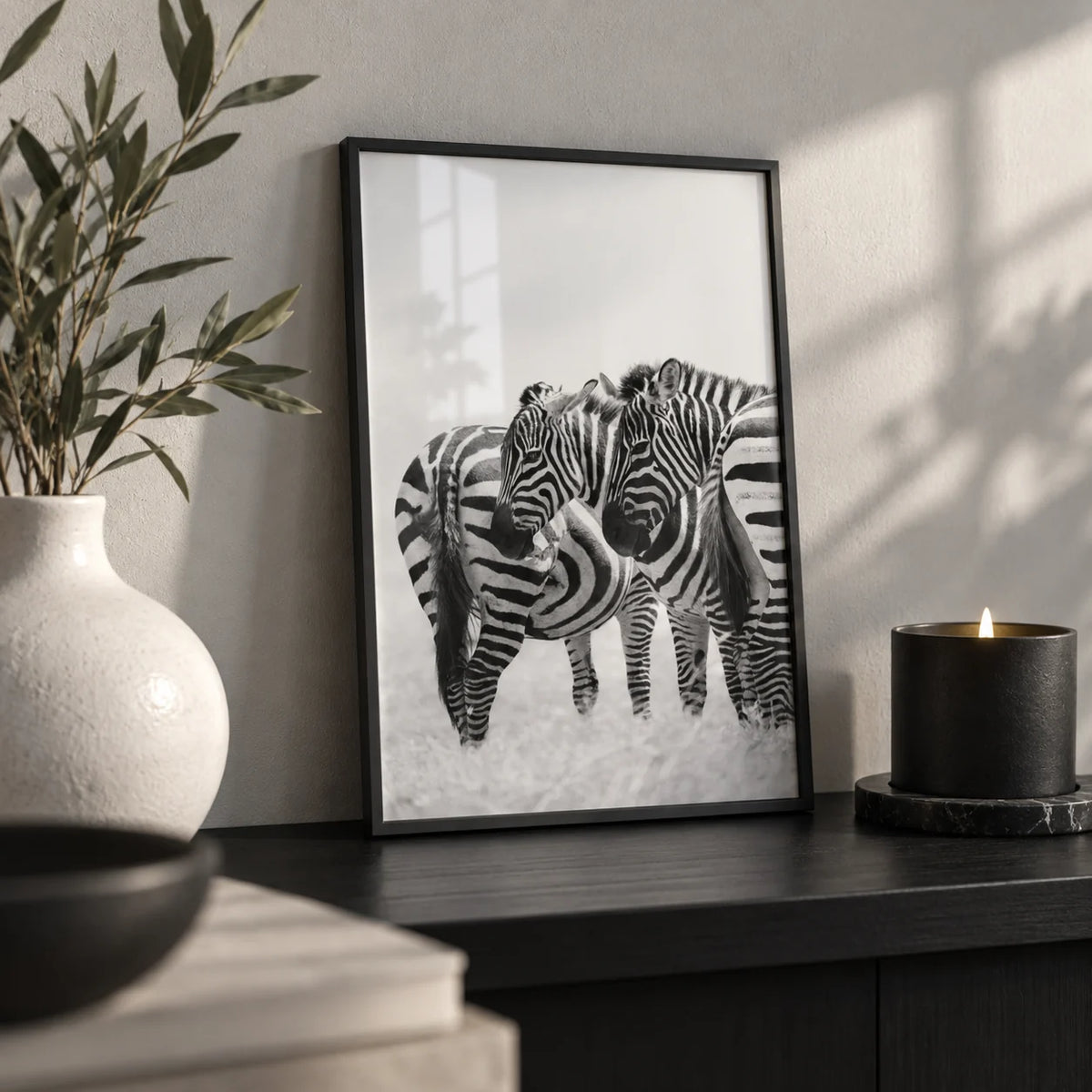 Zebra Wall Art, a small A4 framed print leaning on a black shelf in a living room
